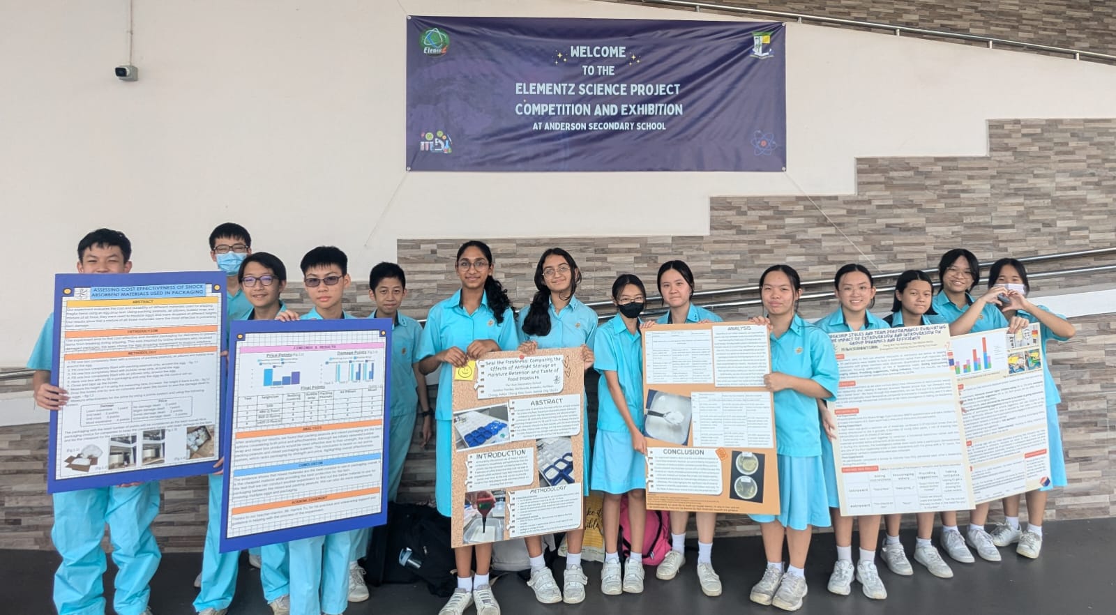 A group of students holding their posters